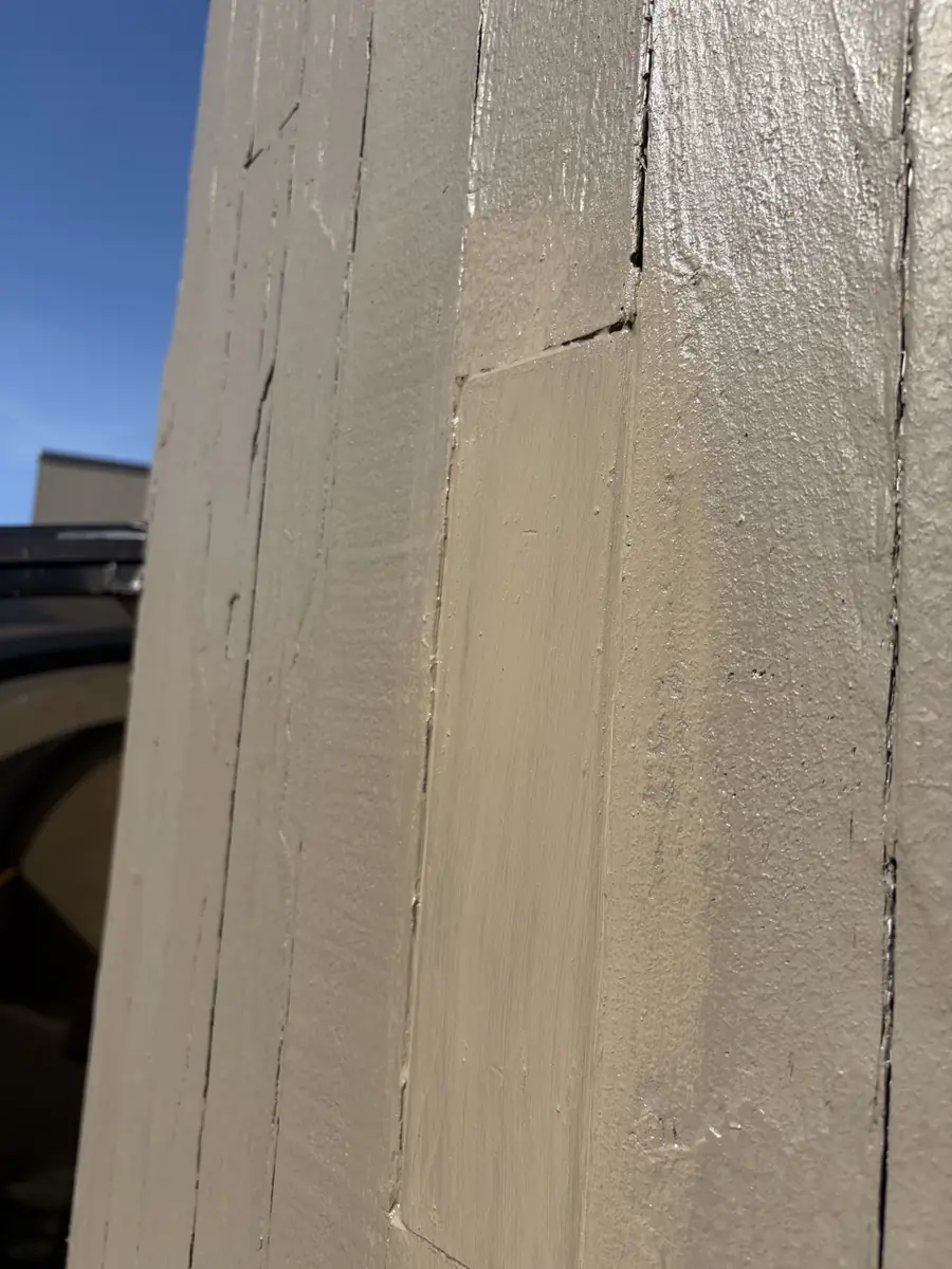 Repaired siding section primed and ready for paint