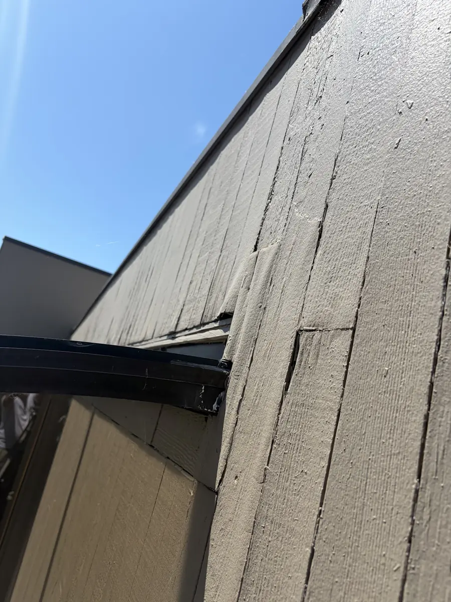 New wood patch fitted into opened siding during repair