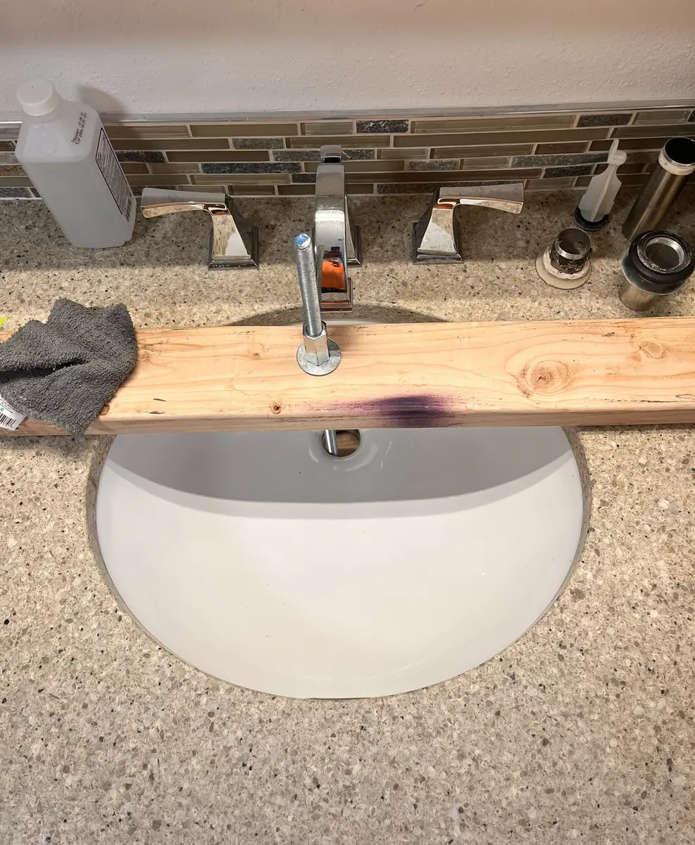Custom wood bracing set up under a bathroom faucet during repair